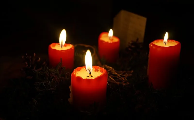 Videncia sin cartas: velas rojas encendidas sobre fondo oscuro
