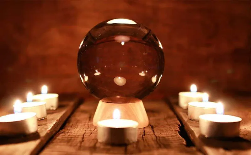 Vidente sin cartas: bola de cristal rodeada de velas encendidas